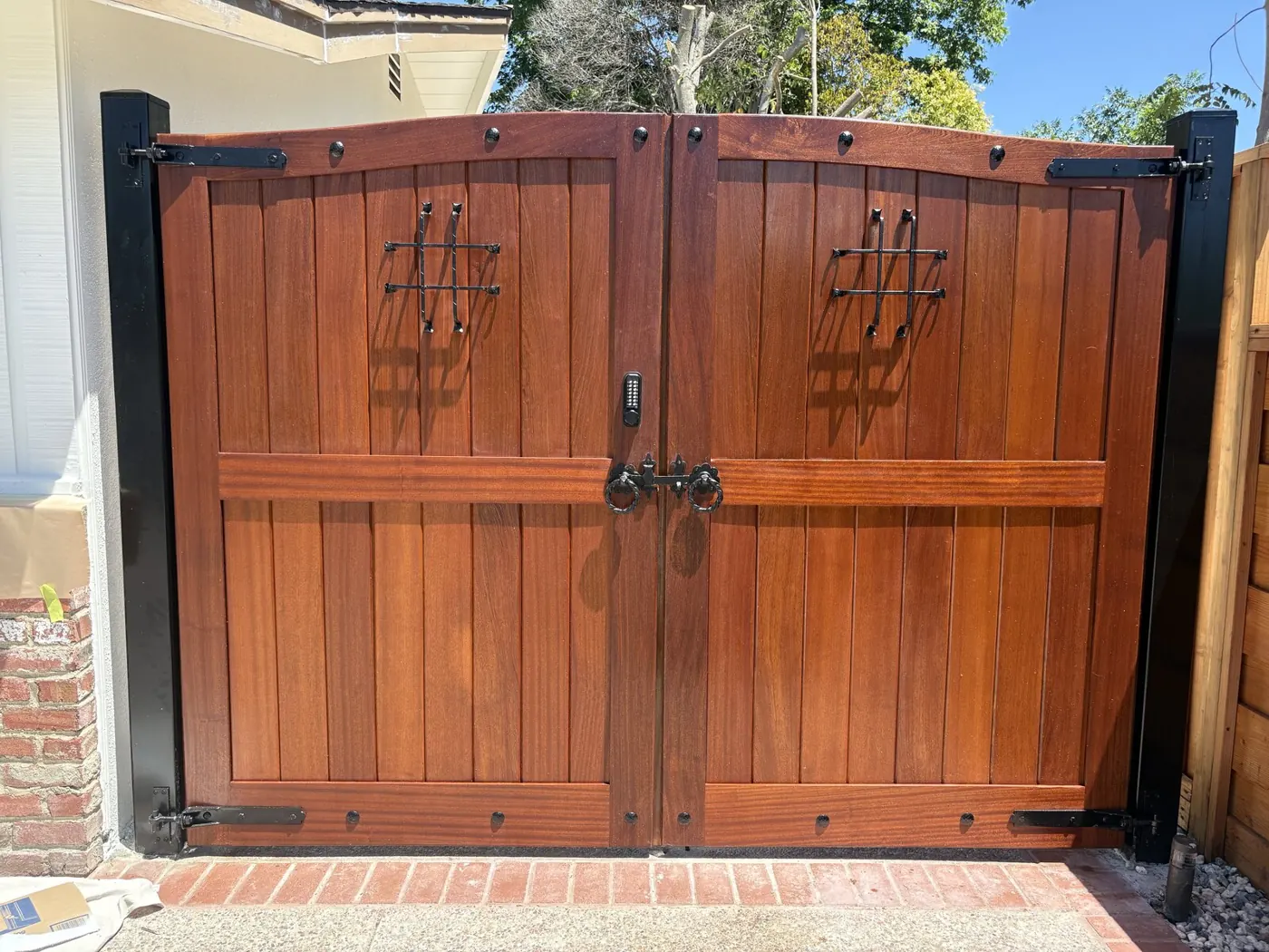 Mahogany Double Driveway Gate with Iron Speakeasies — Walnut Creek, CA - Driveway Gate — handcrafted custom gate by Heartwood Gates, Concord, CA